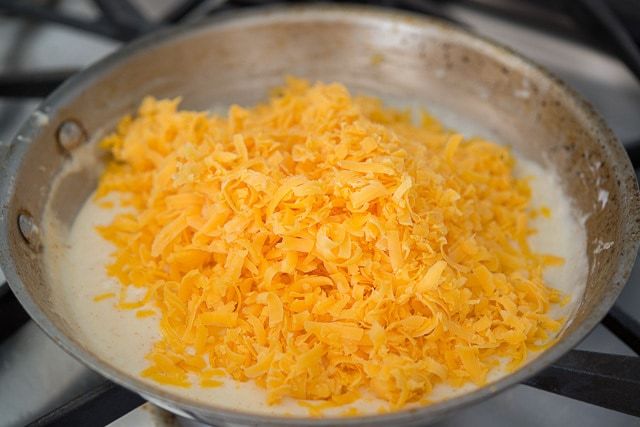 Shredded Cheddar Cheese Added to Skillet Roux