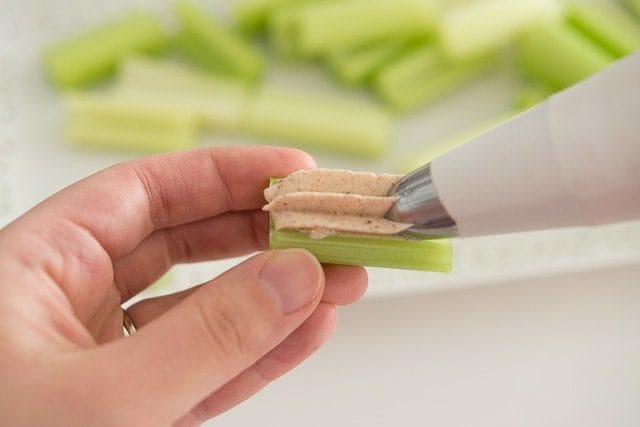 Piping Spiced Goat Cheese Into Celery Pieces