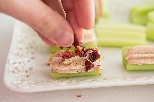 Adding Chopped Dried Cranberries to Celery Log
