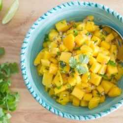 Overhead View of Mango Salsa With Fresh Chopped Cilantro In Blue Bowl