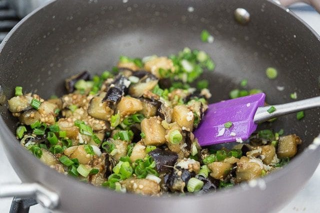 Green Onion Added to Cooked Chopped Eggplant in Pan