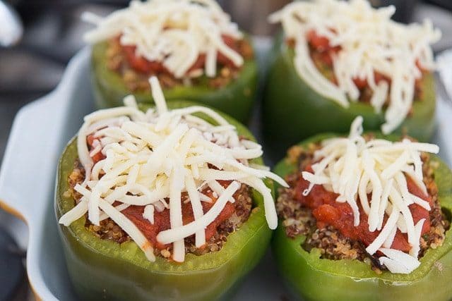 Unbaked Stuffed Green Peppers with Marinara and Cheese On Top