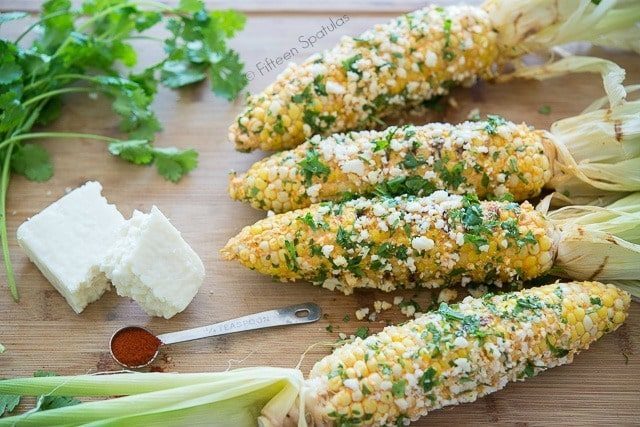 Mexican Corn Cobs on Board with Cilantro and Cheese