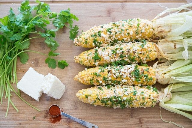 Cobs of Corn Coated in Cotija Cheese and Cilantro