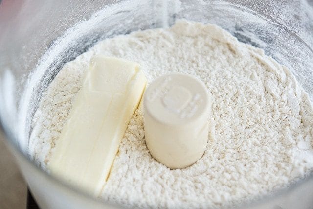 Flour In Food Processor Bowl with Stick of Butter