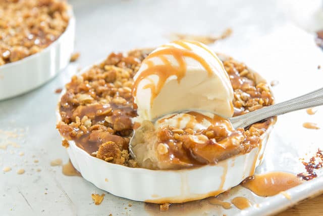 Apple Crisp with Oats with a Scoop of Vanilla Ice Cream and Caramel Drizzle on Spoon