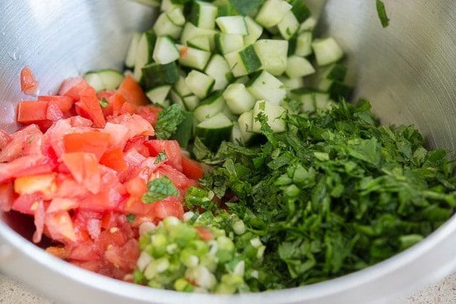 Chopped Cucumber, Tomatoes, Scallions, and Herbs in a Bowl