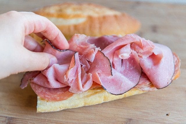 Adding sliced Black Forest Ham Onto Bread