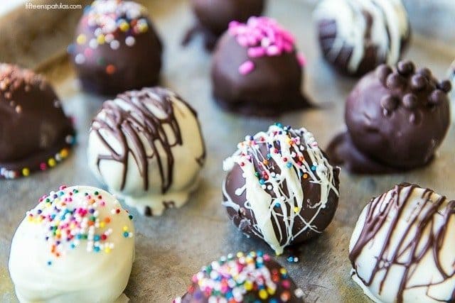 Decorated Oreo Truffles on a Sheet Pan with Sprinkles and Chocolate Drizzle