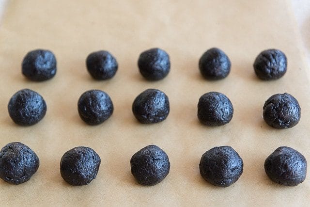 Rolled Oreo Truffles On Parchment Paper Ready to be Dipped in Chocolate
