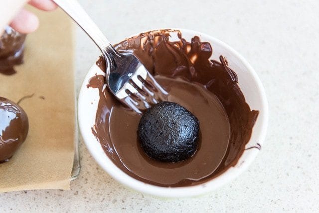 Dunking Oreo Balls Into Melted Milk Chocolate