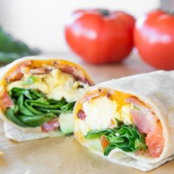 Breakfast Burrito Cut in Half to Show Filling of Eggs and Cheese