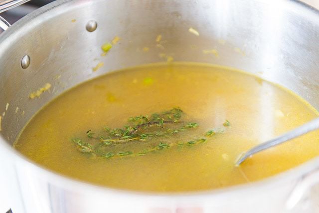 Chicken Stock in Soup Pot with Floating Thyme