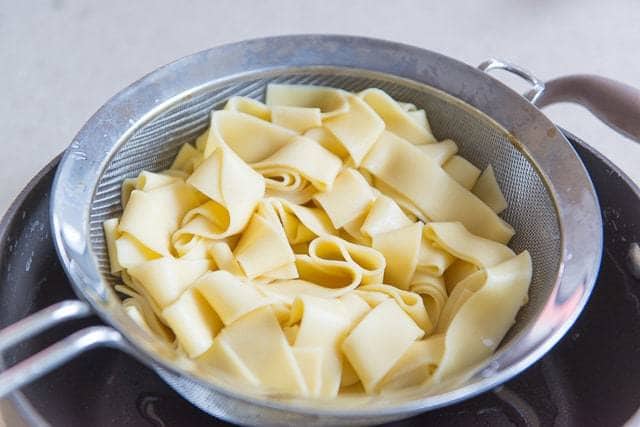 Cooked Pappardelle in a Fine Mesh Strainer