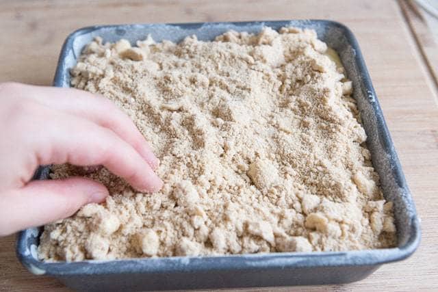 Spreading Crumb Topping on Top With Fingers