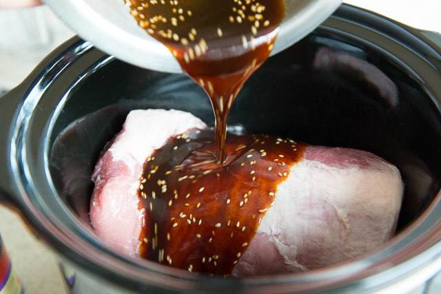 Pouring Asian Sesame Marinade on Pork in Crockpot