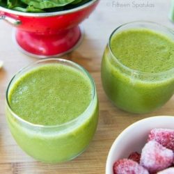 Green Smoothies with Spinach and Strawberries on Wooden Board