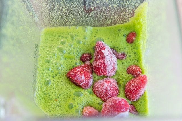 Frozen Strawberries in Blender Jar with Green Juice