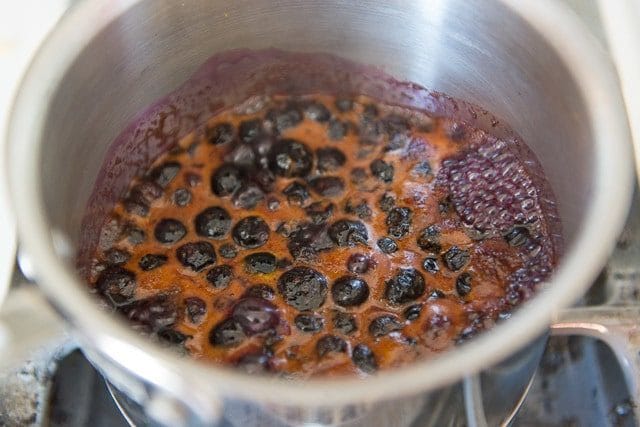 Simmering Blueberries in Saucepan with Orange Juice