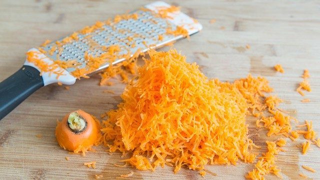 Shredded Carrots on a Cutting Board
