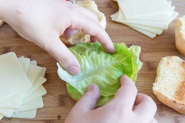 Adding Butter Lettuce to Toasted Buns