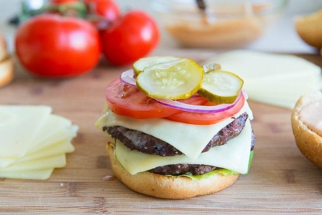 Pickles, Red Onion, Tomatoes, added to Bun with Two Beef Patties and Cheese Slices