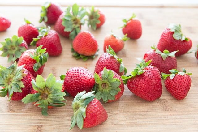 Strawberries with Stems On Cutting Board