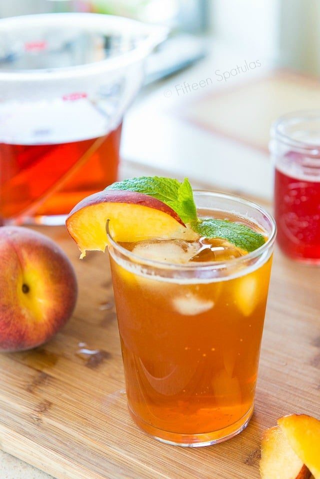 Peach Iced Tea - Sparkling in a Glass with Peach Garnish and Mint 
