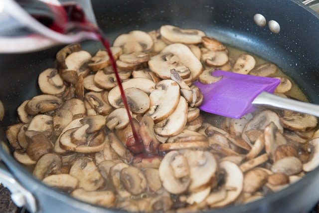 Pouring Red Wine Into Mushroom Sauce