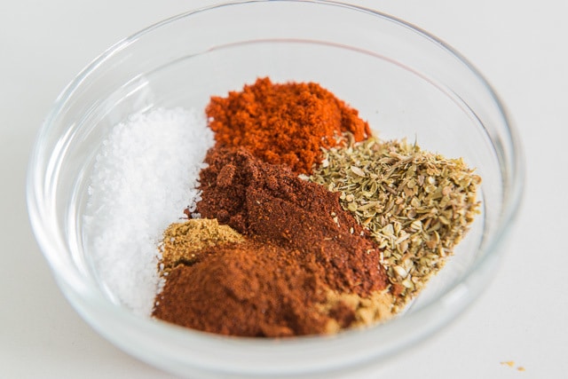 An assortment of spices and salt in mixing bowl