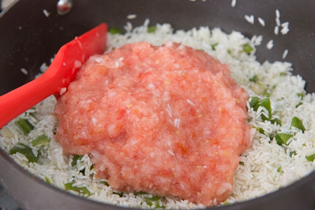 Tomato Onion Mixture Added to Rice in Pot