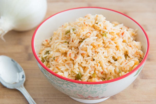 Mexican Rice Recipe - In a Bowl with Spoon on Wooden Board