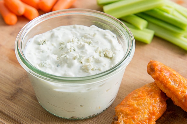 Blue Cheese Dressing - On a Wooden Board with Wings, Celery, and Carrot Sticks