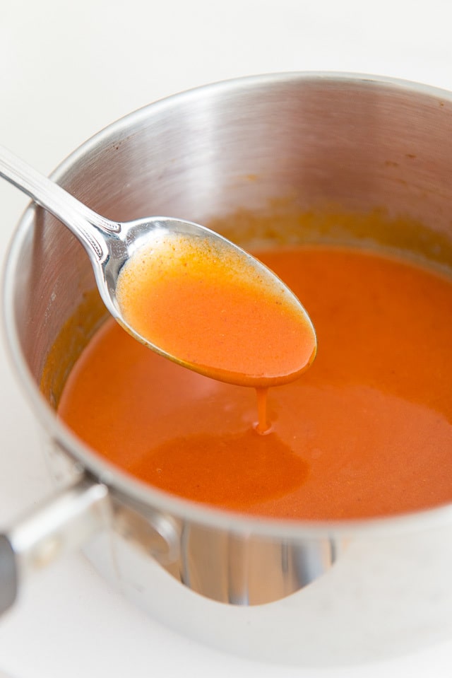 Buffalo Wing Sauce - With Spoon and Saucepan Showing Texture