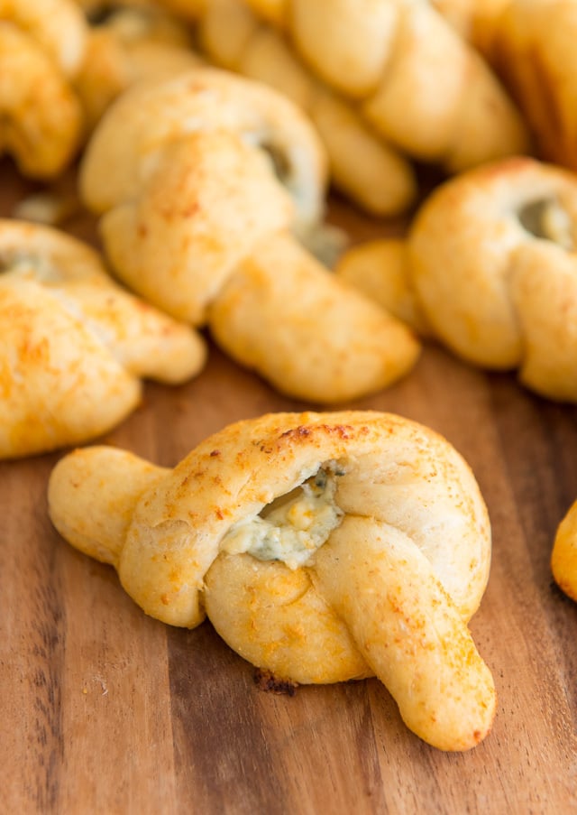 Buffalo Garlic Knots Piled on Wooden Board with Blue Cheese Filling
