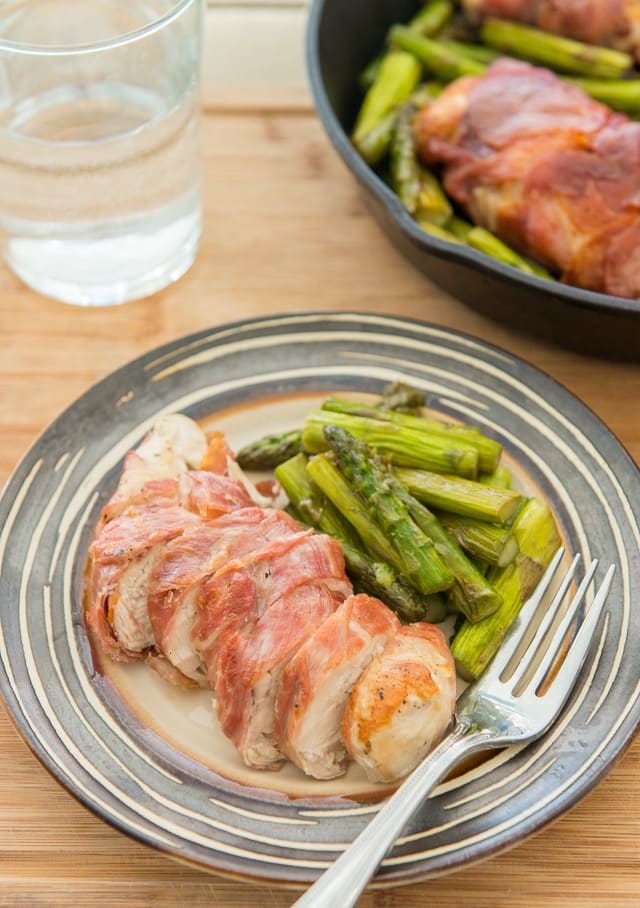 Prosciutto Wrapped Chicken Breast - sliced on a Plate with Asparagus