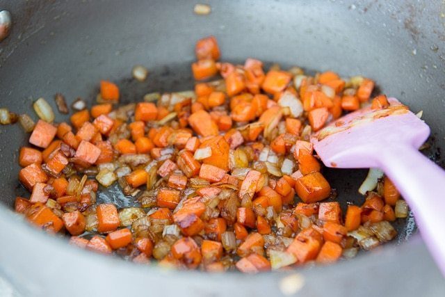 Sauteing chopped carrots and onion in nonstick pan