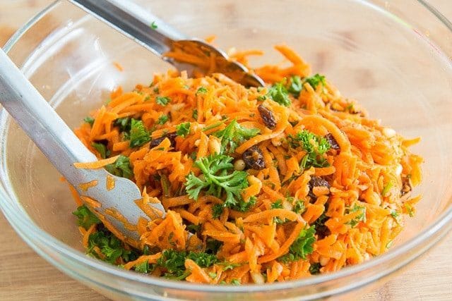 Grated Carrot Salad in Bowl with Raisins and Parsley