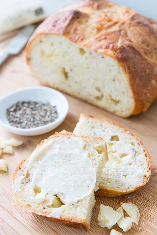 Asiago Black Pepper Bread - Sliced and Spread with Fresh Butter 