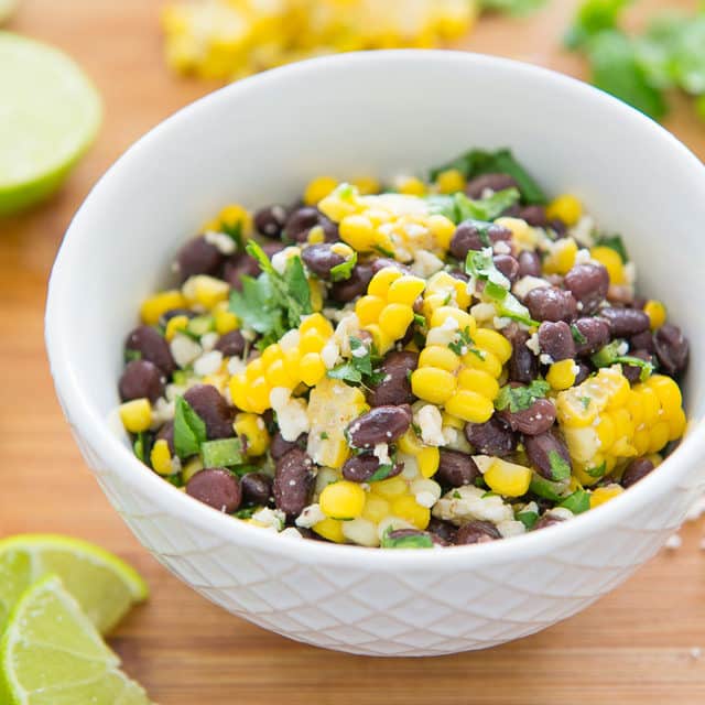 Black Beans and Corn Salad in White Bowl with Herbs and Lime