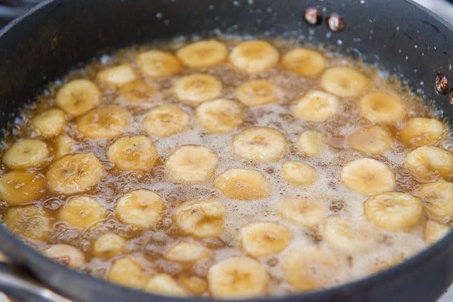 Banana Slices Simmering in Bananas Foster Sauce in Skillet