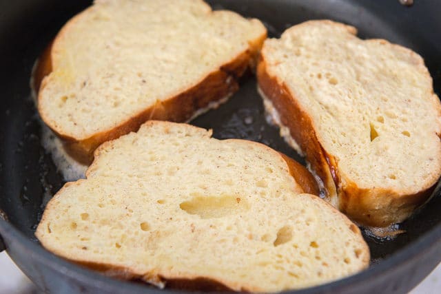 Cooking Custard Soaked Challah French Toast in Butter in Skillet