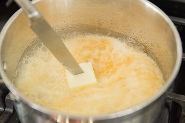 Stirring Butter Pat Into Foaming Homemade Caramel Sauce