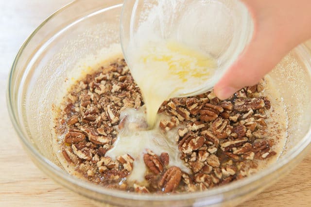 Pecans and Melted Butter Being Added To Filling Mixture For Maple Pecan Bars
