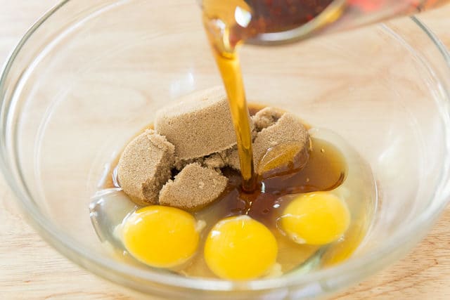 Runamok Maple Syrup Pouring Into Duralex Bowl With Three Eggs And Brown Sugar