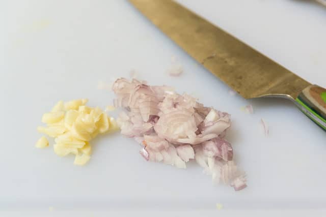 Chopped Shallots and Garlic on Cutting Board