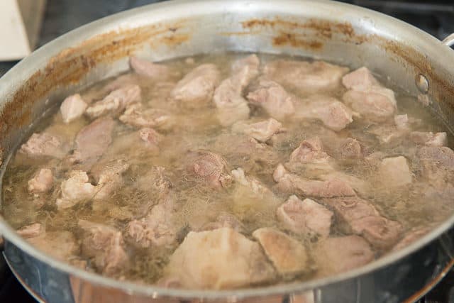 Simmering Pork Shoulder Carnitas Chunks in Saucepan