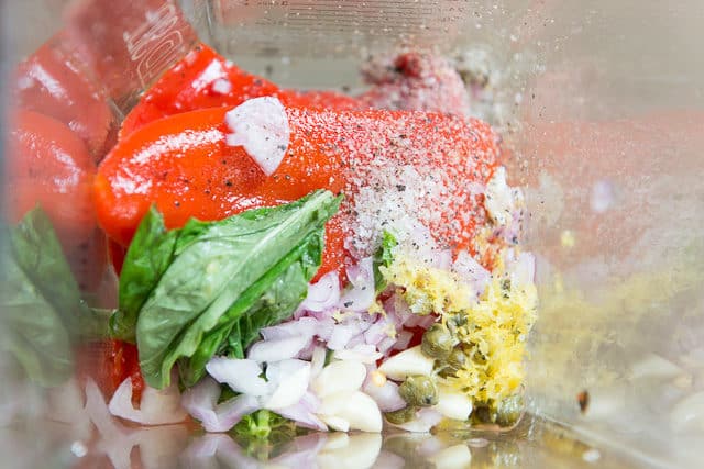 Roasted Red Peppers, Fresh Basil Leaves, Chopped Shallot, Minced Garlic, Lemon Zest, Capers, Salt, And Pepper In A Blendtec Wildside Jar
