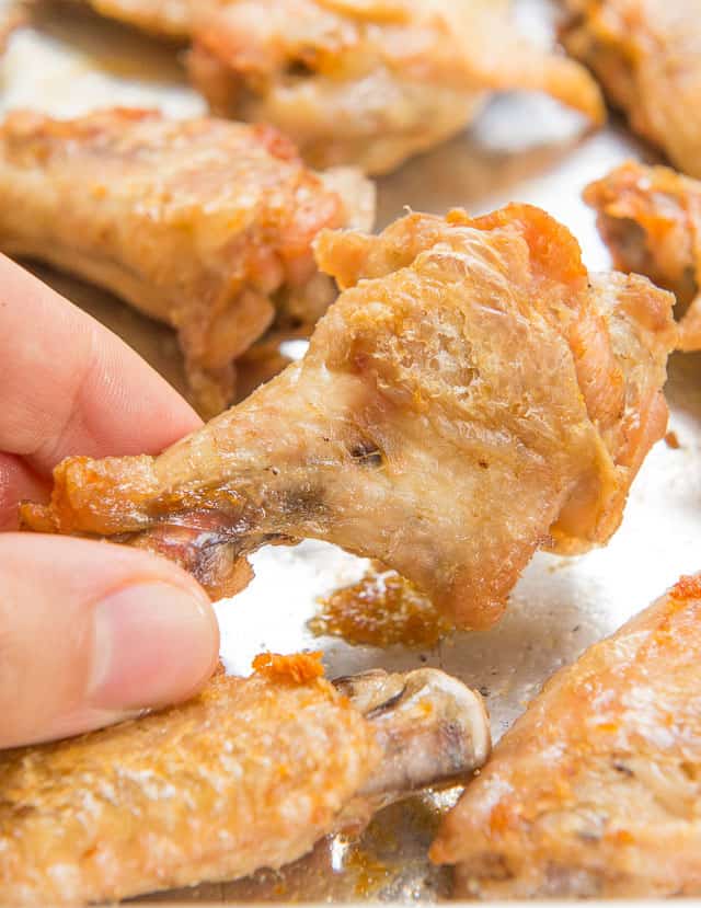 Crispy Baked Chicken Wings On a Sheet Pan with Close Up Showing Crispy Texture