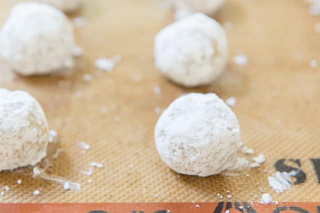 Crinkle Cookie Dough Balls Rolled In Powdered Sugar On Silpat Silicone Mat